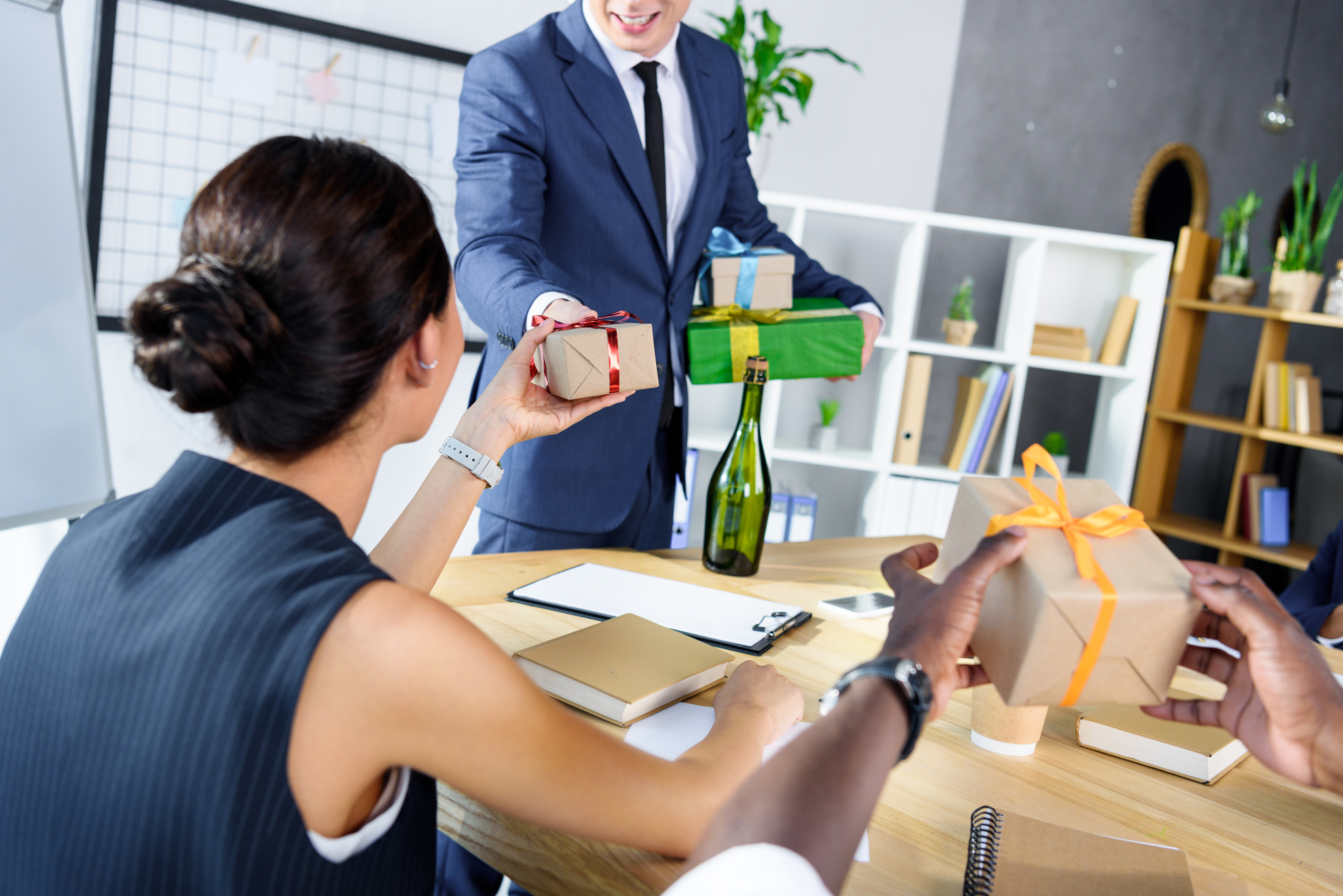 an office worker giving out presents to their colleagues